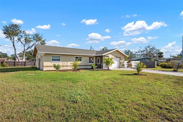 ranch-style house featuring a front lawn, an attached garage, fence, and driveway