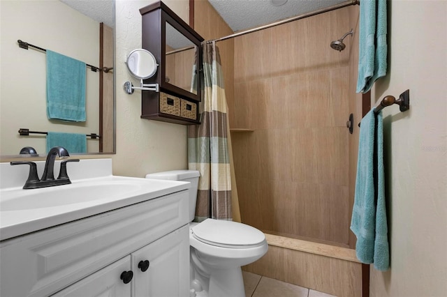 full bath with tile patterned floors, toilet, vanity, and a textured ceiling