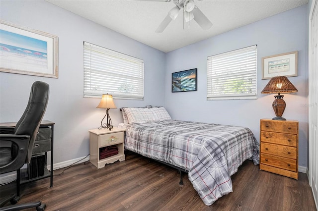 bedroom featuring baseboards, wood finished floors, and a ceiling fan