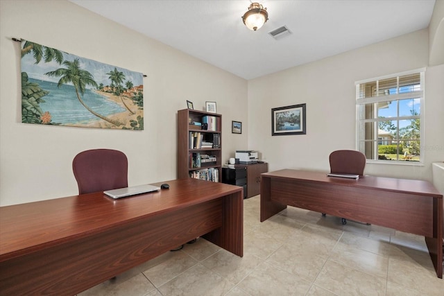 office area featuring light tile patterned floors and visible vents