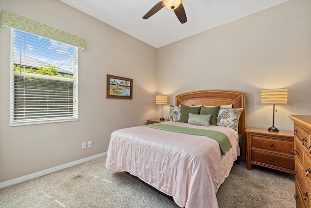 bedroom with baseboards, carpet floors, and a ceiling fan