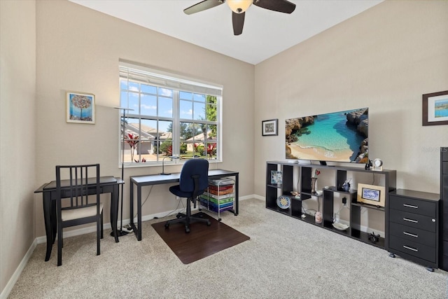 carpeted office with a ceiling fan and baseboards