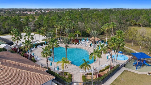 drone / aerial view featuring a wooded view