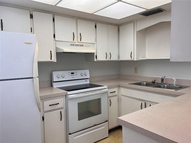 kitchen featuring visible vents, under cabinet range hood, a sink, white appliances, and light countertops