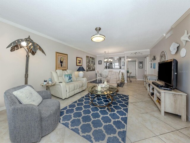 living room with light tile patterned floors, baseboards, a chandelier, and crown molding