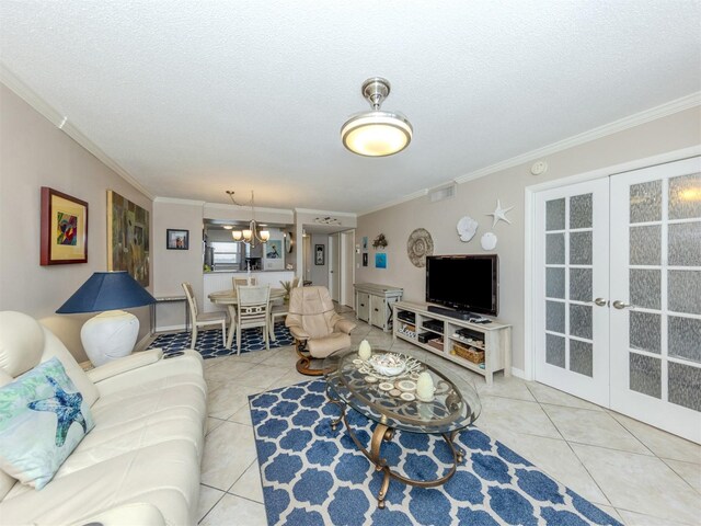 tiled living room with french doors, an inviting chandelier, and ornamental molding