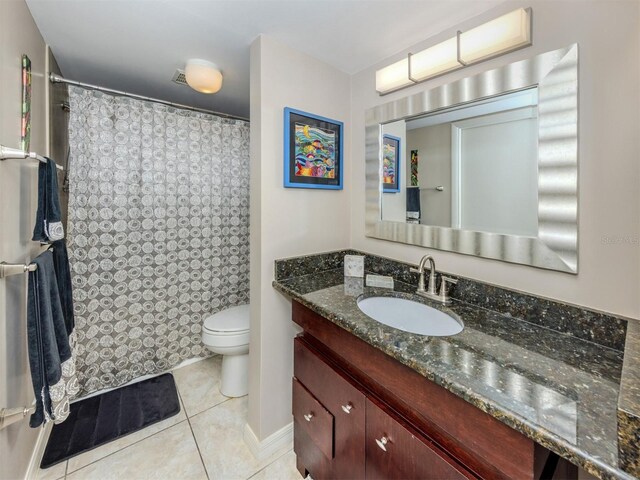 full bath with a shower with shower curtain, toilet, vanity, and tile patterned flooring