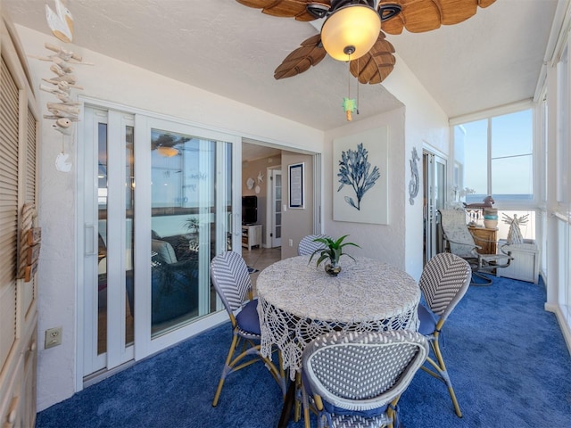sunroom featuring a ceiling fan