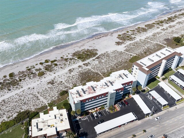 birds eye view of property with a beach view and a water view