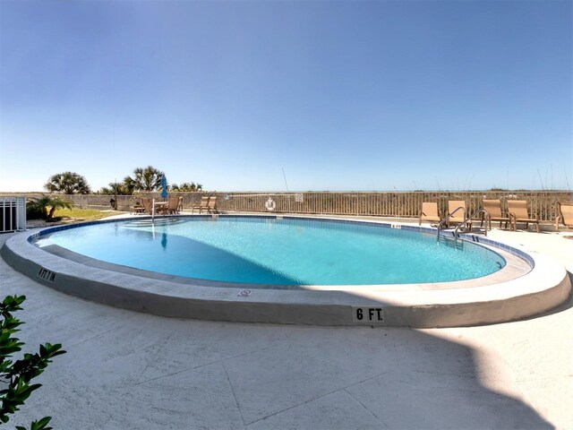 pool featuring a patio and fence
