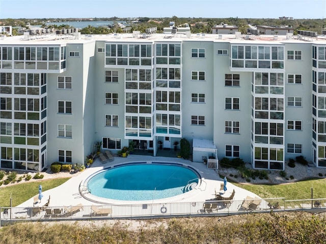 community pool featuring a patio area and fence