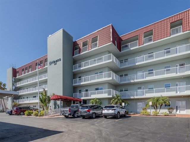 view of property featuring uncovered parking
