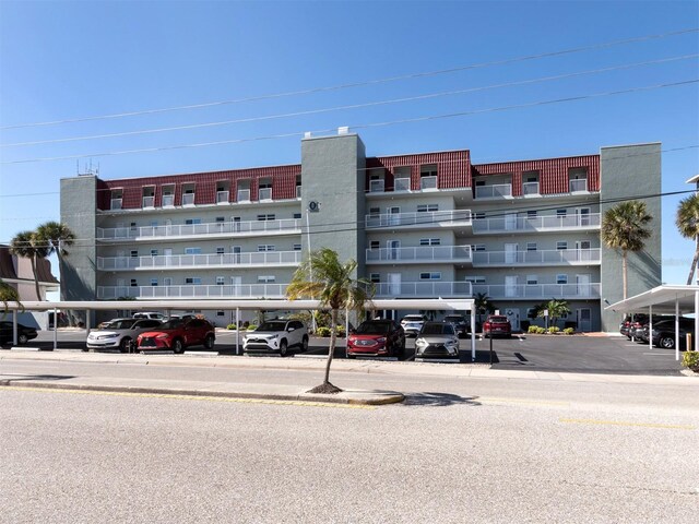 view of building exterior featuring covered parking
