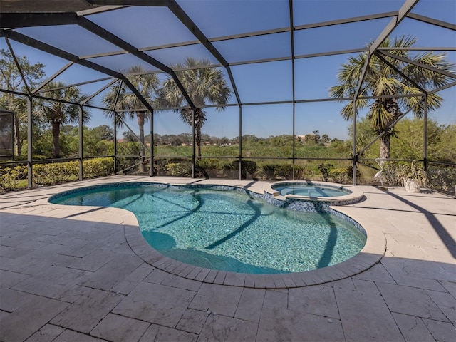 view of pool featuring a patio, a lanai, and a pool with connected hot tub