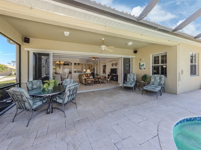 view of patio / terrace with a lanai and ceiling fan