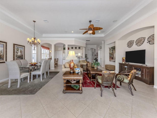 living area featuring a tray ceiling, light tile patterned flooring, and crown molding