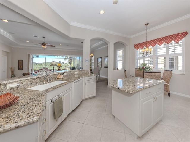 kitchen with a sink, white cabinetry, white dishwasher, and crown molding