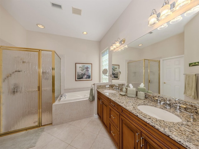 bathroom featuring visible vents, a garden tub, and a sink