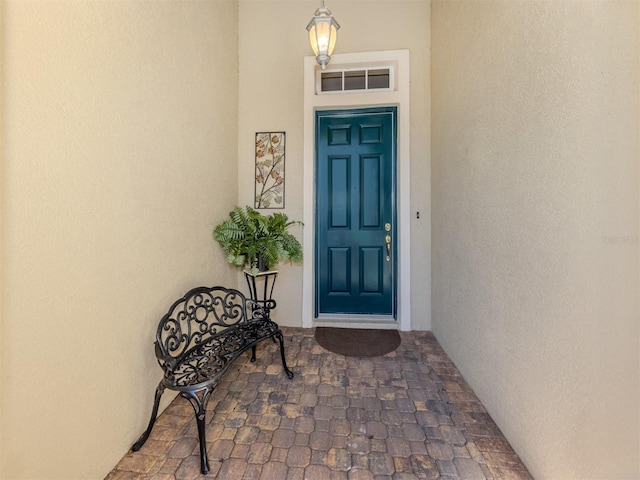 property entrance with stucco siding