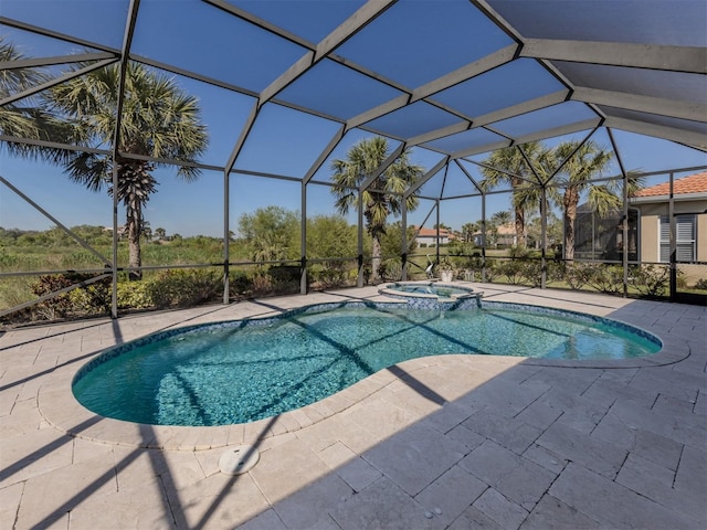 view of pool with glass enclosure, a pool with connected hot tub, and a patio