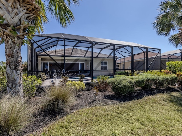 back of house with a lanai and an outdoor pool