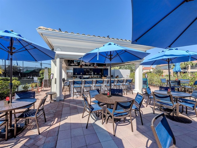 view of patio with outdoor dining space and fence