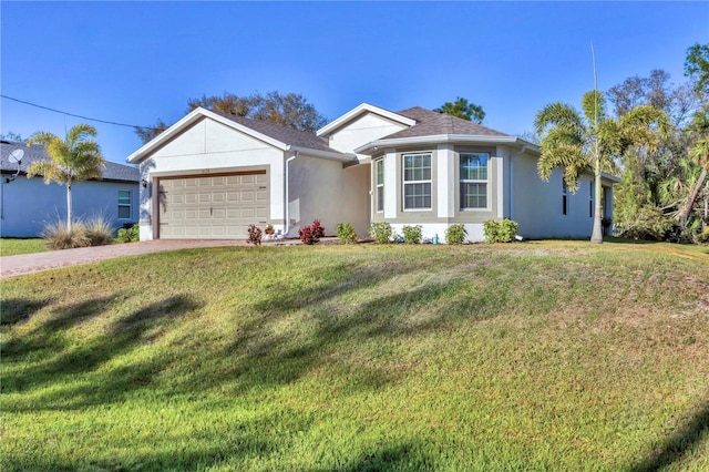 ranch-style house with stucco siding, an attached garage, a shingled roof, and a front yard