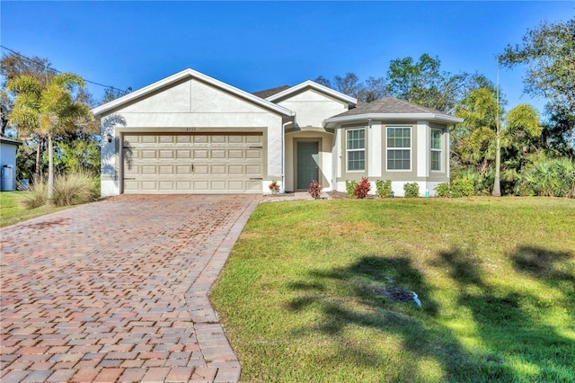 single story home with decorative driveway, an attached garage, a front lawn, and stucco siding