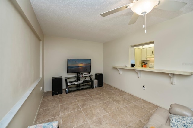 358 Pineview Dr, Venice, FL 34293 - living room with ceiling fan, light tile patterned floors, and a textured ceiling