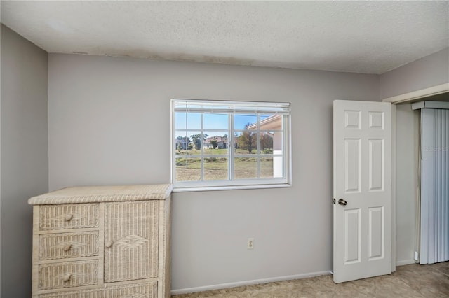 358 Pineview Dr, Venice, FL 34293 - unfurnished bedroom featuring a textured ceiling and baseboards