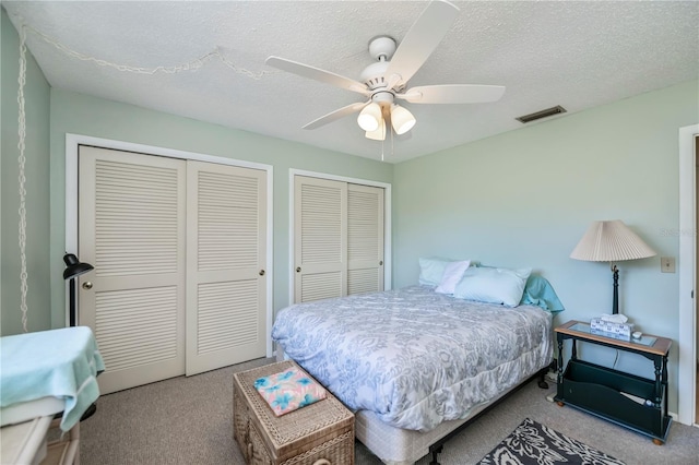 358 Pineview Dr, Venice, FL 34293 - bedroom with visible vents, multiple closets, carpet floors, a textured ceiling, and a ceiling fan