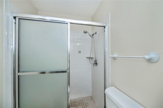 358 Pineview Dr, Venice, FL 34293 - full bath with a textured ceiling, a shower stall, and toilet