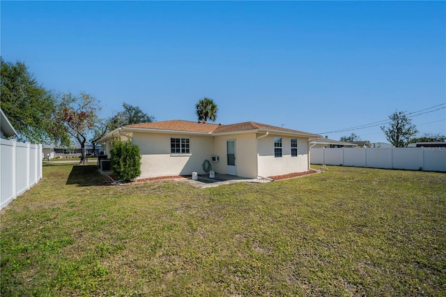 358 Pineview Dr, Venice, FL 34293 - back of property featuring a fenced backyard, a lawn, and stucco siding