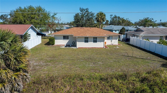 358 Pineview Dr, Venice, FL 34293 - rear view of property featuring a yard, a fenced backyard, and stucco siding