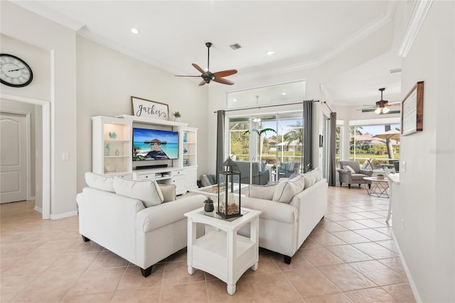 living area featuring visible vents, baseboards, ornamental molding, light tile patterned floors, and a ceiling fan