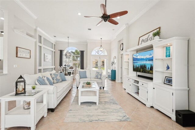 living room featuring light tile patterned floors, visible vents, ornamental molding, and ceiling fan