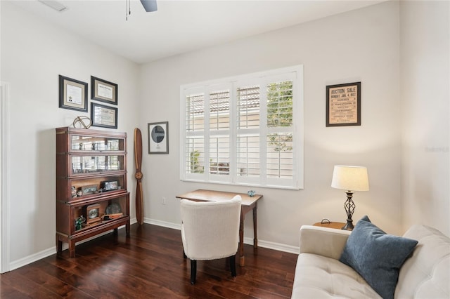 living area featuring baseboards, wood finished floors, and ceiling fan