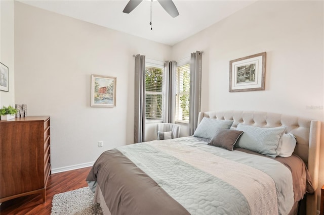 bedroom with baseboards, a ceiling fan, and dark wood-style flooring