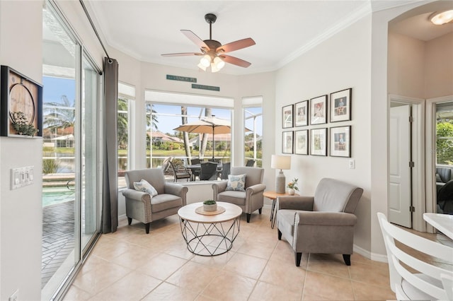 interior space featuring ornamental molding, a healthy amount of sunlight, light tile patterned floors, and ceiling fan