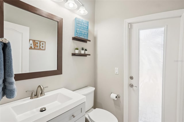 bathroom featuring toilet and vanity