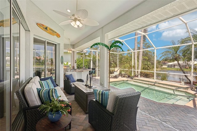 sunroom featuring a swimming pool, a ceiling fan, a water view, and a wealth of natural light