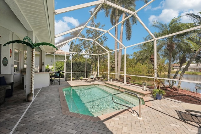 pool featuring glass enclosure and a patio