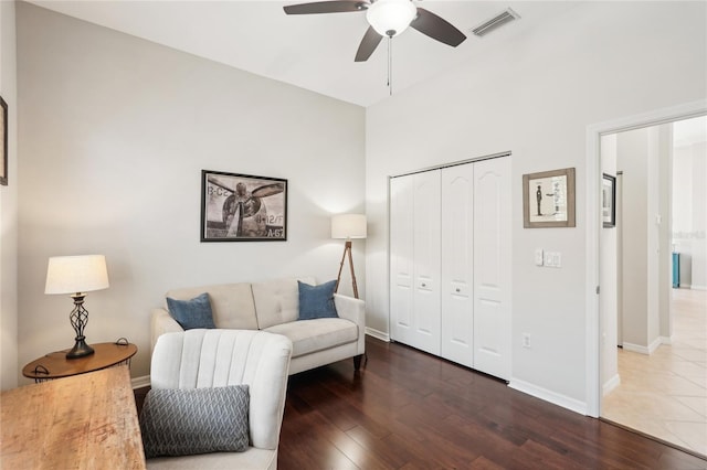 sitting room featuring wood finished floors, a ceiling fan, visible vents, and baseboards