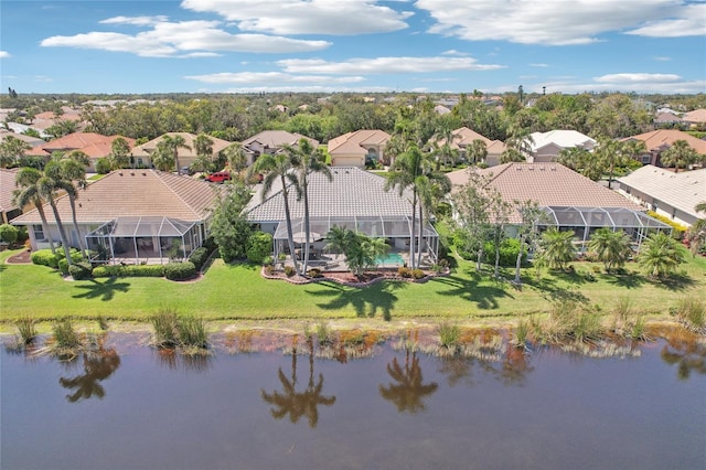 drone / aerial view featuring a residential view and a water view