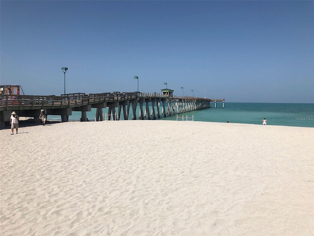 view of water feature featuring a pier and a view of the beach