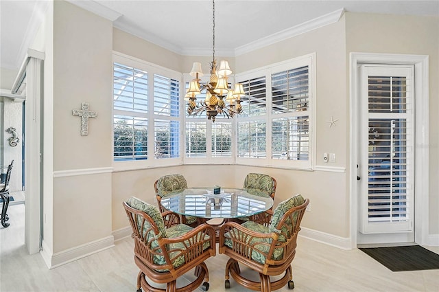 dining area featuring baseboards, crown molding, an inviting chandelier, and wood finished floors