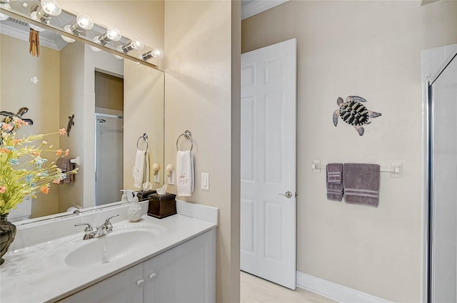 bathroom with a shower with door, baseboards, vanity, and tile patterned floors