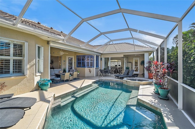 view of swimming pool with a pool with connected hot tub, a lanai, a ceiling fan, and a patio area