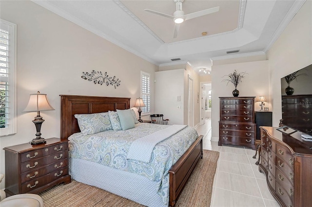 bedroom featuring light tile patterned flooring, visible vents, a raised ceiling, and ornamental molding