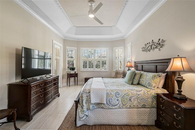 bedroom with baseboards, a raised ceiling, ceiling fan, and ornamental molding